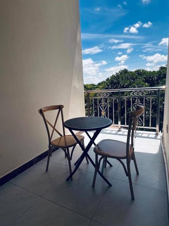 Room Balcony with Seating Table and Chairs under Blue Sky